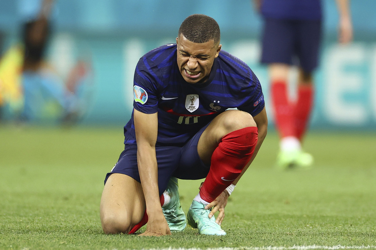 France's Kylian Mbappe grimaces in pain after a challenge during the Euro 2020 soccer championship round of 16 match between France and Switzerland at the National Arena stadium, in Bucharest, Romania, Monday, June 28, 2021. (Marko Djurica/Pool Photo via AP) 