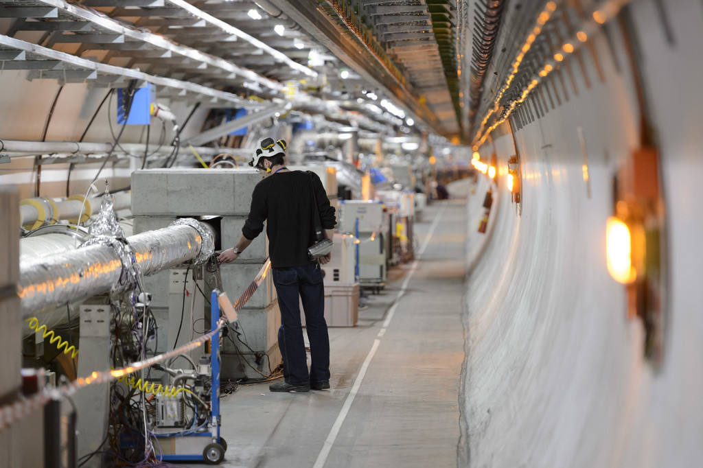 Das Cern bei Genf gibt grünes Licht für den LHC, den „Large Hadron Collider“. Die ringförmige Anlage liegt im schweizerisch-französischen Grenzgebiet 100 Meter unter Boden und hat einen Durchmesser von 27 Kilometern. Im LHC-Tunnel kreisen Protonen und Ionen in Röhren mit sehr hoher Energie (7 Teraelektronenvolt) in gegenseitiger Richtung und prallen aufeinander. So werden Zustände wie direkt nach dem Urknall erreicht. Durch die Kollision erhofft man sich weitere Erkenntnisse über den Ursprung unseres Unive…