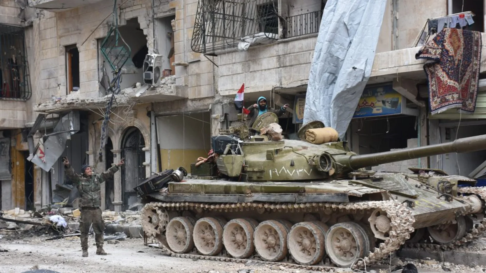 Aleppo nach dem Fall: Jubelnde syrische Soldaten im bis vor kurzem schwer bombardierten Quartier Sukkari im Osten der eroberten nordsyrischen Metropole. Das Bild stammt von der offiziellen syrischen Nachrichtenagentur SANA. (Foto: Keystone/EPA/SANA)
